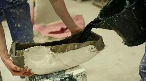 Bronze foundry worker pouring melted wax into a pot Stock Footage 58640093