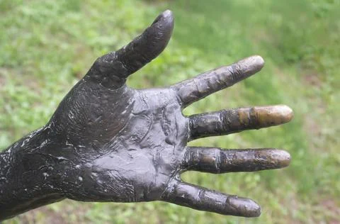 Bronze hand of a statue Stock Photos