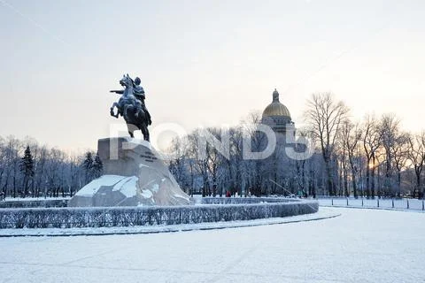 Bronze horseman monument and St. Isaac's Cathedral on winter morning in St. Stock Photos