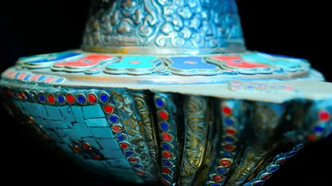 Bronze Indian pitcher richly decorated with ornaments and red and blue tiles   Stock Footage 121592336