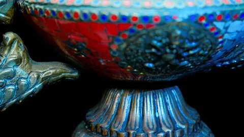 Bronze Indian pitcher richly decorated with ornaments and red and blue tiles   Stock Footage 121592535