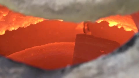 Bronze ingots begin to melt in the crucible Stock Footage 256037845