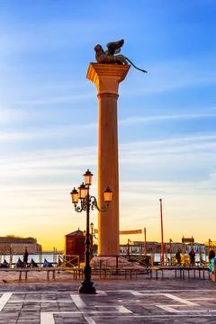 The bronze lion of St. Mark on a column in Piazza San Marco at dawn in Veni.. Stock Photos