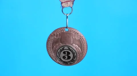 Bronze medal on a blue background Video stock 60384596