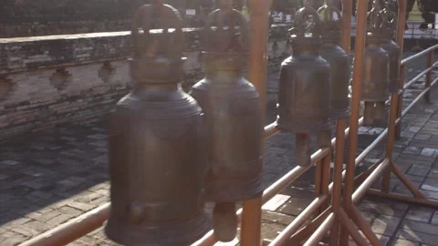 Bronze Prayer Bells Ringing in a Tranquil Thai Temple Setting Stock-Footage 333706078