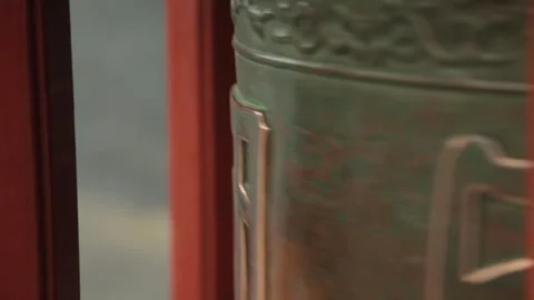 Bronze Prayer Wheel Rotating Between Red Pillars at Lama Temple in Beijing Stock Footage 345829532