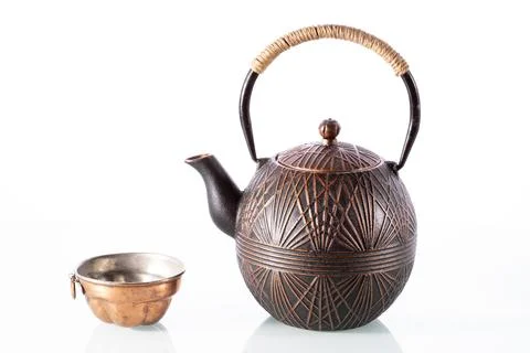 Bronze retro kettle placed on a plain white surface, showcasing its elegant a Stock Photos