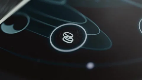 Bronze stack of cost tokens occupies the center of a circular orbit formed Stock Footage 343376107