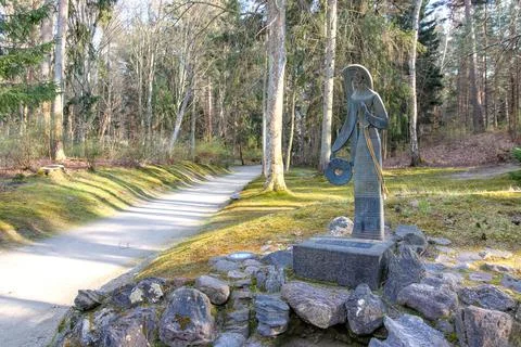 Bronze statue on a forest path in early spring Stock Photos