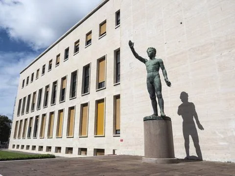 Bronze statue Genio dello Sport outside the Palazzo degli Uffici, Faschist... Stock Photos