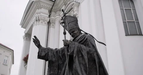 Bronze statue of Pope John Paul II in front of Basilica on main squar Stock Footage 314000251