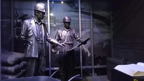 Bronze Statues of Construction Workers in Hard Hats Stock Photos