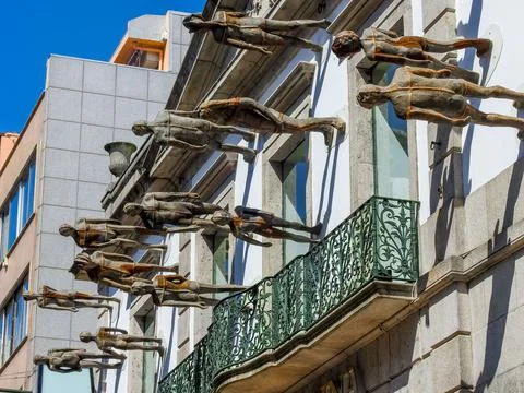 Bronze statues walking on the facade Stock Photos