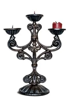 Bronze three-headed old candlestick with a candle of a red candle Stock Photos