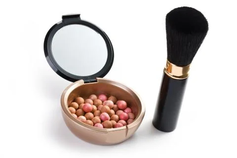 Bronzing pearls and makeup brush Stock Photos