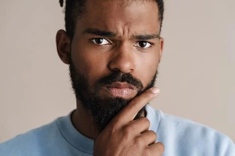 Brooding african american guy posing and looking at camera Fotos de archivo