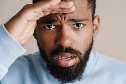Brooding african american guy posing and looking at camera Fotos de archivo