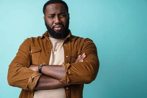 Brooding african american man posing with arms crossed Stock Photos