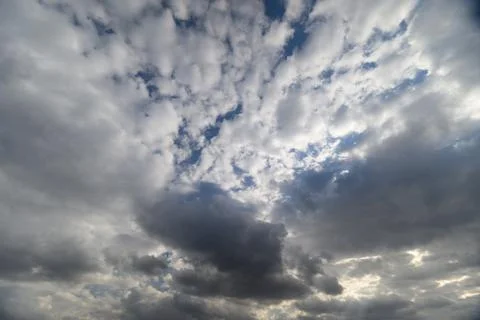 Brooding clouds gather over horizon, deep shadows and cool palette create moo Stock Photos