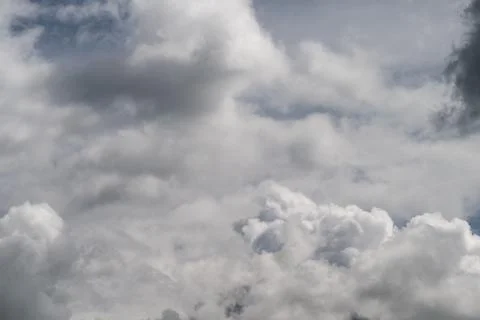 Brooding clouds symbolize climate uncertainty and risk, heavy atmosphere, edi Stock Photos