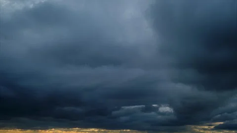 Brooding, dramatic storm clouds gather, hinting at an approaching tempest, 스톡 동영상 308160739
