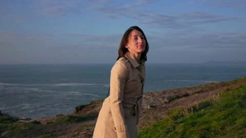 A brooding girl walks along the ocean Stock Footage 171833442