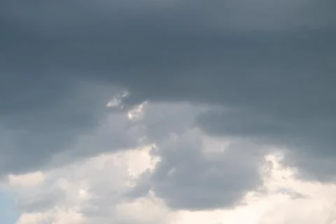 Brooding gray clouds dominate stormy sky, chaser monitoring pressure, texture 写真素材