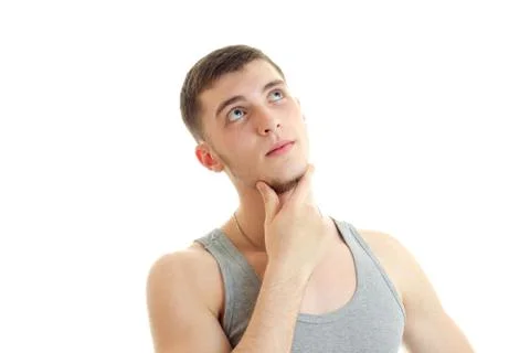 Brooding handsome guy lifted his head up and keeps your hand near the Chin close Stock Photos