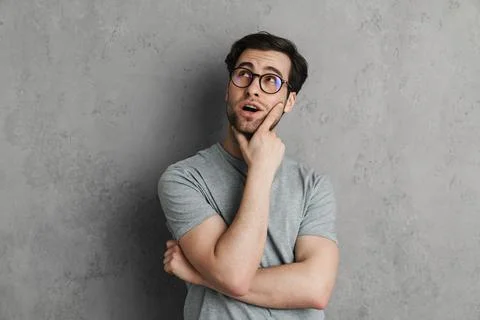 Brooding handsome guy thinking and looking upward Stock Photos