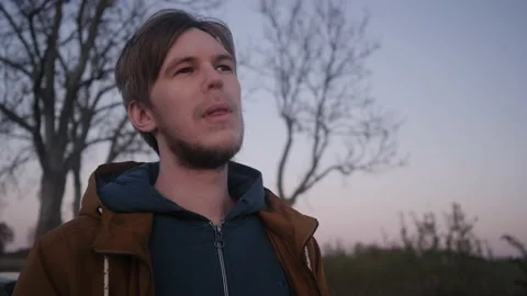 Brooding look into the distance the young man and e-cigarette vapor Stock Footage 131360753