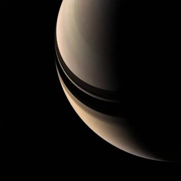 Brooding Saturn seems to be missing its rings, but their shadows on the pl... Stock Photos