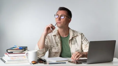 A brooding student teaches lessons at a laptop Stock Photos