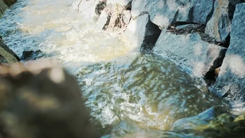 Brook flowing toward the light between stone banks Видео 137778062