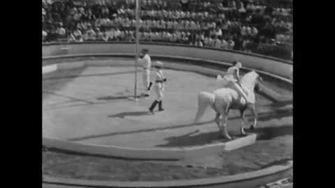 BROOKLYN - 1930 - A circus performer rides a horse around a ring at Coney Stock Footage 308178850