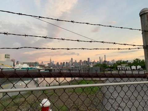 Brooklyn Barbed Wire Fence Overlooking Manhattan NYC Early Morning Skyline Stock Photos