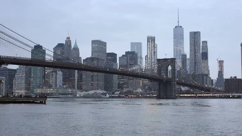 Brooklyn Bridge and lower Manhattan on an overcast evening Stock Footage 79549819