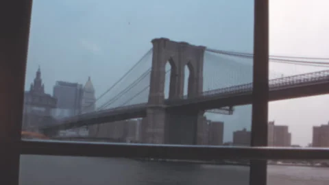 Brooklyn Bridge and Manhattan skyline from East River, United States 1960s 스톡 동영상 344954399