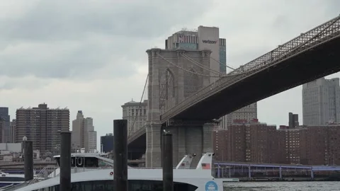 The Brooklyn Bridge Stands Majestically Over Water Beneath Cloudy Skies of New Stock Footage 295009023