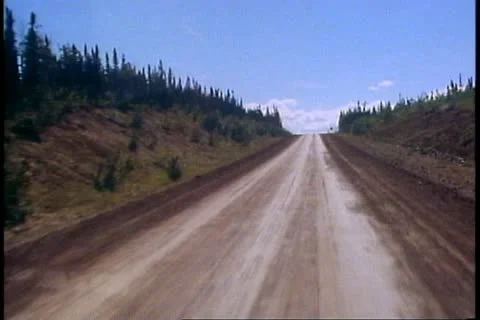 BROOKS RANGE, ALASKA, 1989, Motor coach,  Dalton Highway, POV road, pine trees Stock Footage 12150547