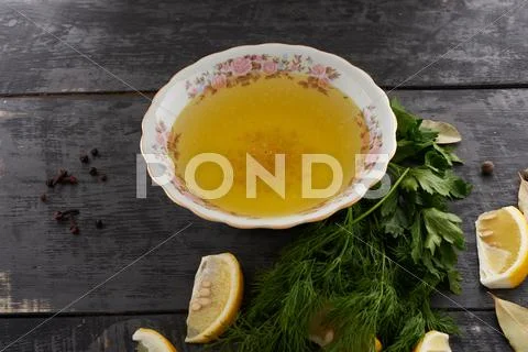 Broth and seasonings in a dish on the table Stock Photos