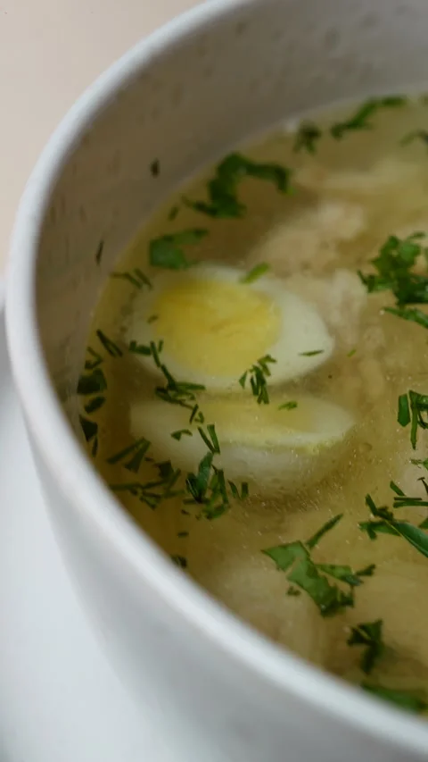 Broth with noodles and egg in a plate rotating, close-up Stock Footage 308745783