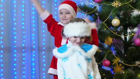 Brother and sister in Christmas costumes... | Stock Video | Pond5