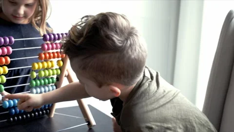 Brother and sister learning to count with multicolor abacus toy Video stock 220100178