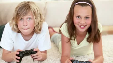 Brother and sister lying while playing video games Video stock 10812280