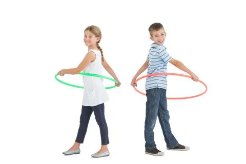 Brother and sister playing with hula hoop Stock Photos