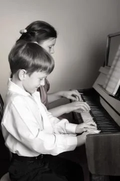 Brother And Sister Playing Piano. Piano player. Foto stock