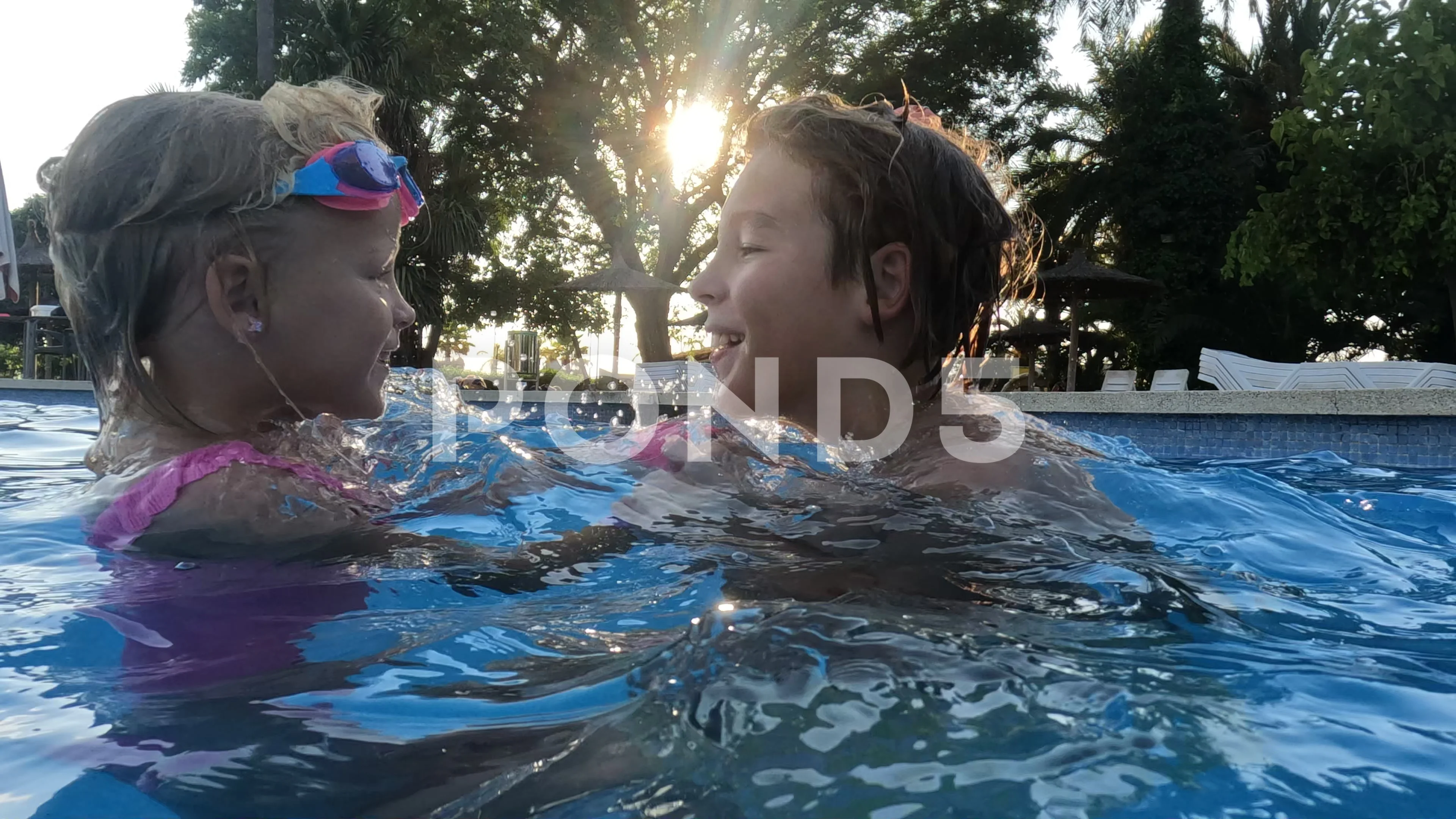 Brother and sister playing in the pool