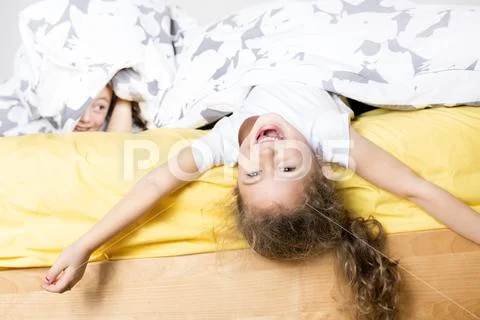 Brother And Sister Relaxing Together In Bed Stock Photos