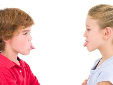 Brother and sister sticking tongues out at each other Stock Photos