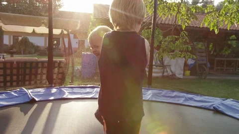 Brother Fall Upset Trampoline - 4k - Slow motion Stock Footage 70448554